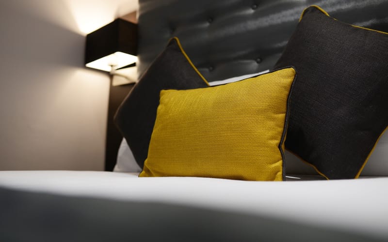Bedlinen and cushions in a room at The 29 London